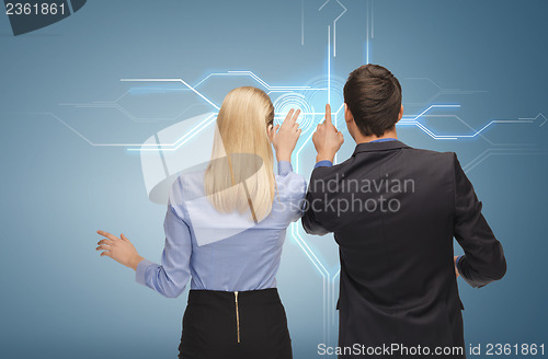 Image of man and woman working with virtual screen