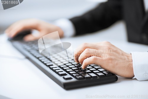 Image of man hands typing on keyboard