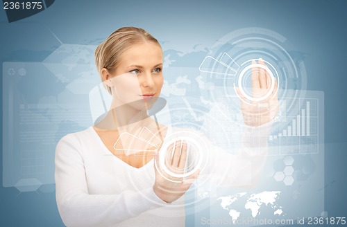 Image of businesswoman touching virtual screen