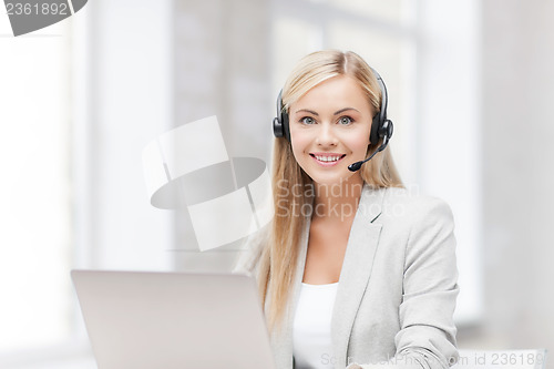 Image of friendly female helpline operator with laptop