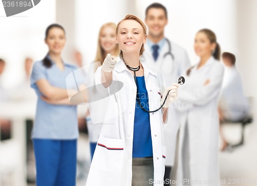 Image of attractive female doctor pointing her finger