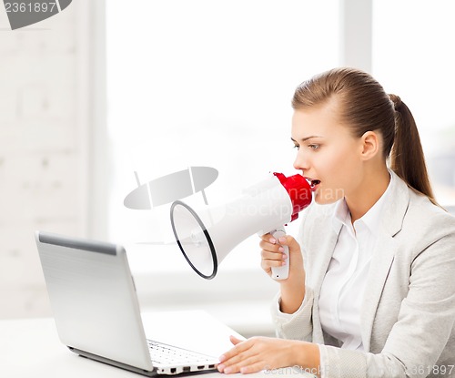 Image of strict businesswoman shouting in megaphone