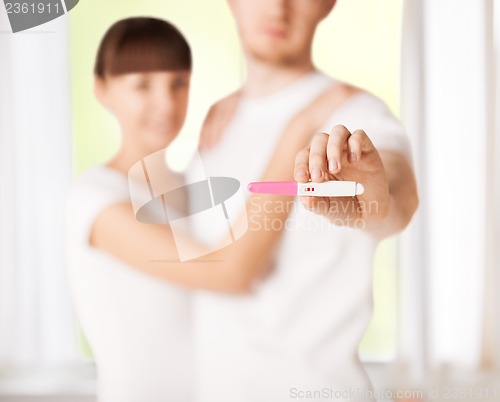 Image of woman and man hands with pregnancy test