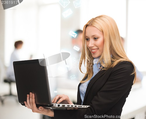 Image of woman with laptop computer in office