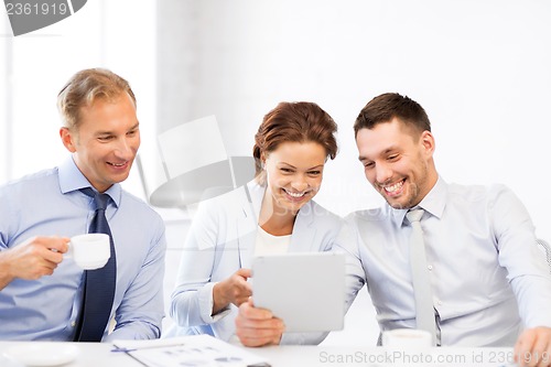 Image of business team having fun with tablet pc in office