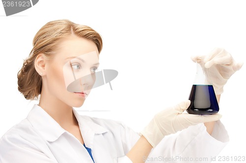 Image of female chemist holding bulb with chemicals