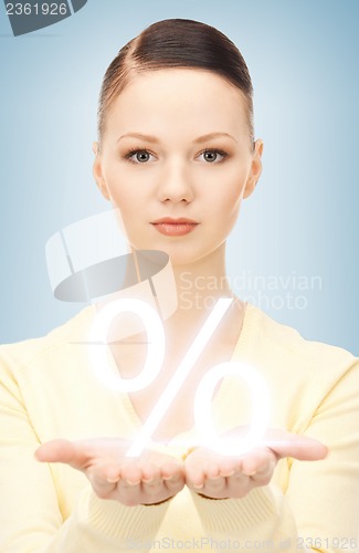 Image of woman showing sign of percent in her hand