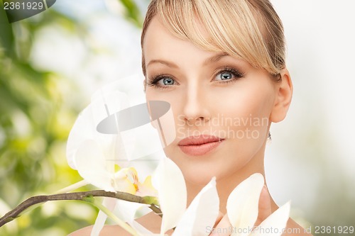 Image of beautiful woman with orchid flower