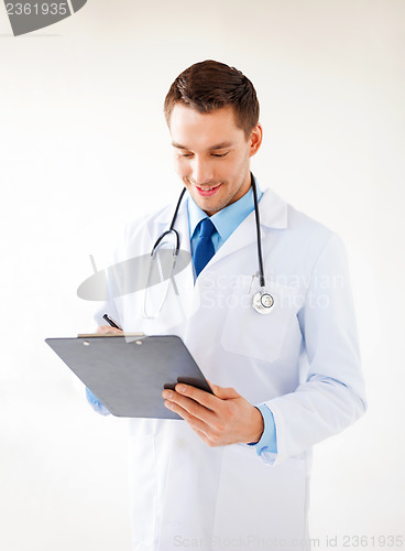 Image of male doctor writing prescription