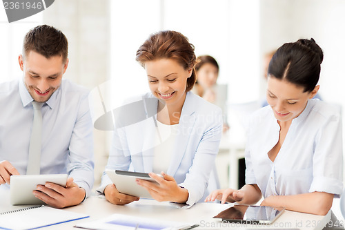 Image of business team working with tablet pcs in office