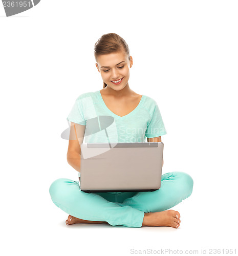 Image of young girl sitting on the floor with laptop
