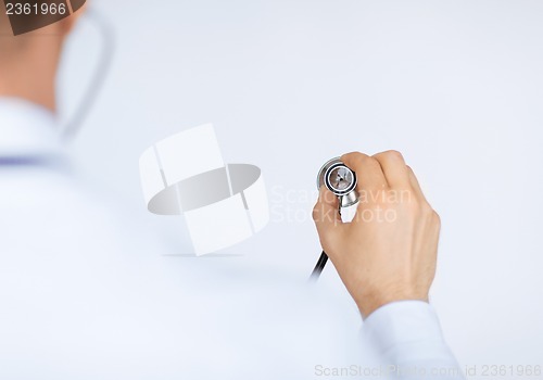 Image of doctor hand with stethoscope listening somebody