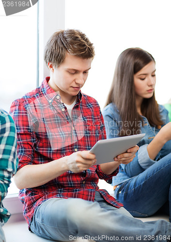 Image of student looking into tablet pc at school
