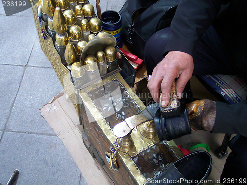 Image of man polishing shoes