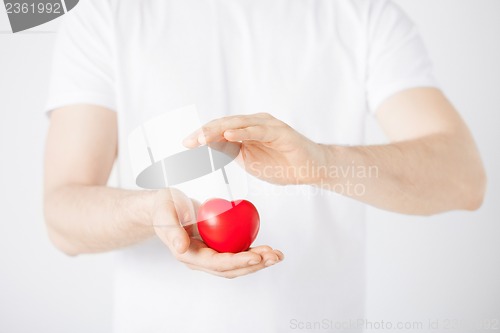Image of man hands with heart