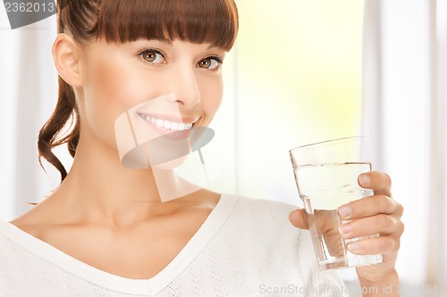 Image of young smiling woman with glass of water