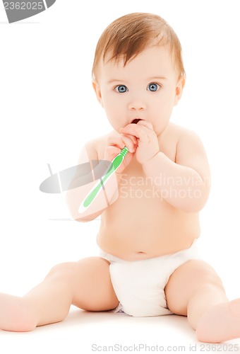 Image of curious baby brushing teeth