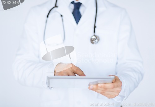 Image of male doctor holding tablet pc