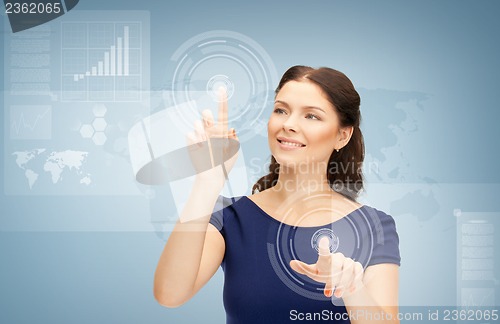 Image of businesswoman touching virtual screen