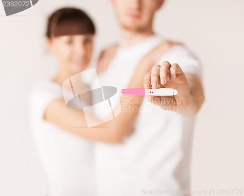 Image of woman and man hands with pregnancy test