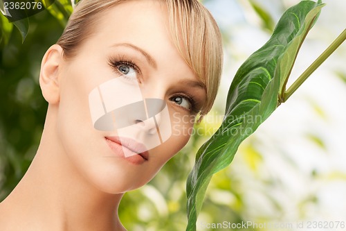 Image of woman with green leaf