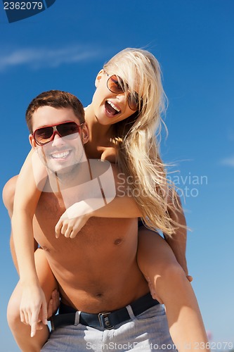 Image of couple having fun on the beach