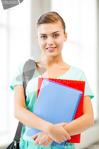 Image of student girl with school bag and notebooks