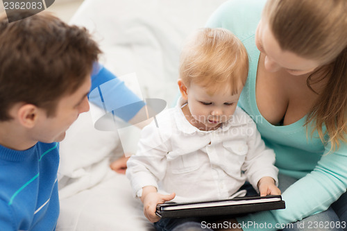 Image of parents and adorable baby with tablet pc