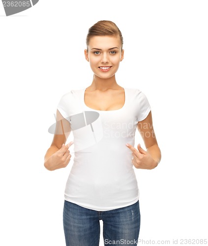 Image of smiling woman pointing at blank white t-shirt