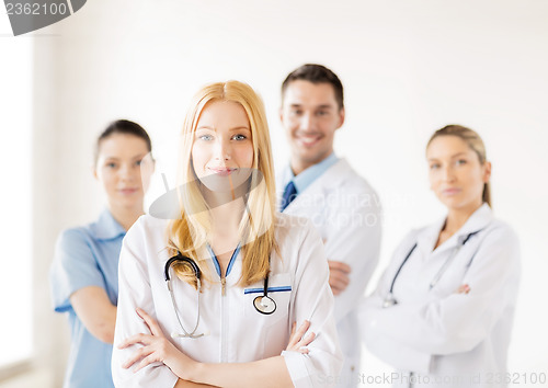 Image of female doctor in front of medical group