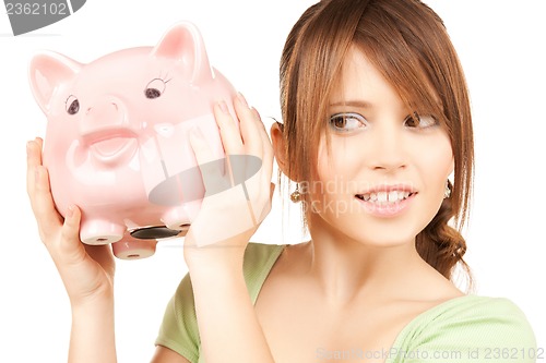 Image of lovely girl with big piggy bank