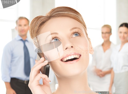 Image of businesswoman with cell phone calling