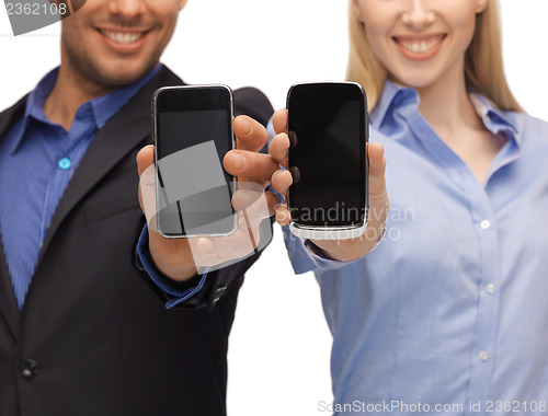 Image of woman and man hands with smartphones