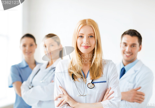 Image of female doctor in front of medical group