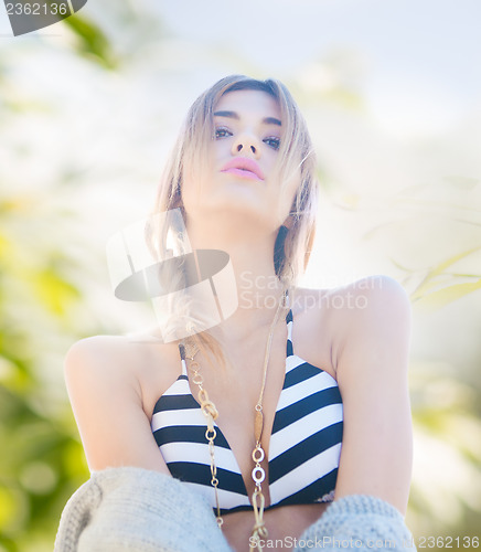 Image of fashion model posing on the beach