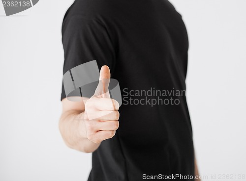 Image of man showing thumbs up