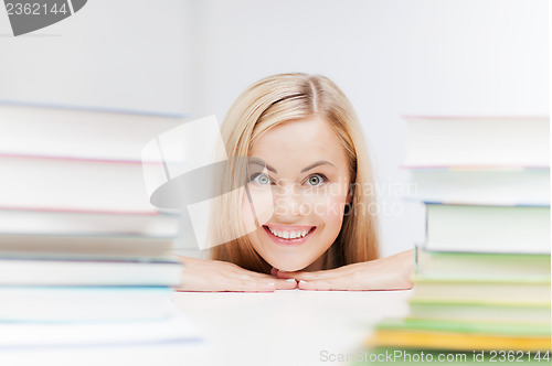 Image of student with stack of books