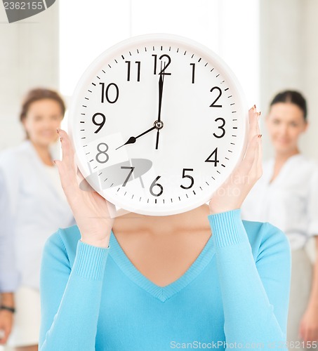 Image of businesswoman with clock over her face