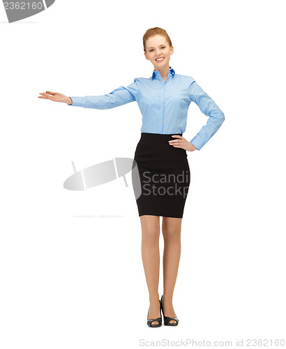 Image of businesswoman showing something with her hand