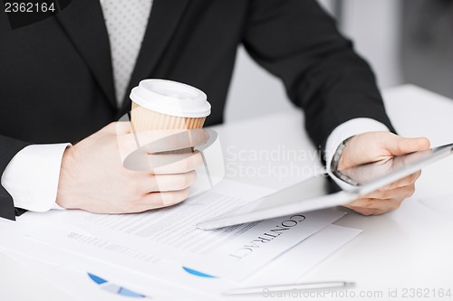 Image of man with tablet pc and cup of coffee