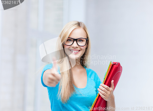 Image of smiling student with folders