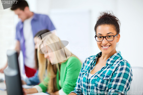 Image of student with computer studying at school