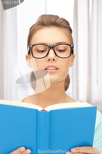 Image of calm and serious woman with book