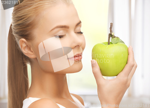 Image of woman smelling apple