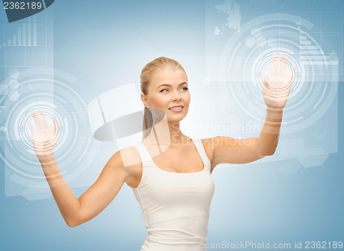 Image of businesswoman touching virtual screen