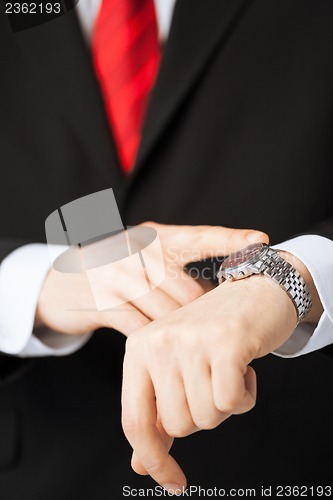 Image of man looking at wristwatch