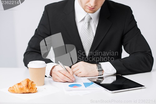 Image of man with tablet pc and cup of coffee