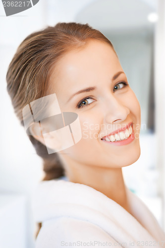 Image of beautiful woman in white bathrobe