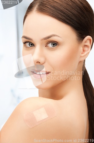 Image of beautiful woman with medical patch or plaster