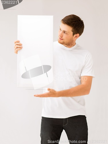 Image of young man holding white blank board